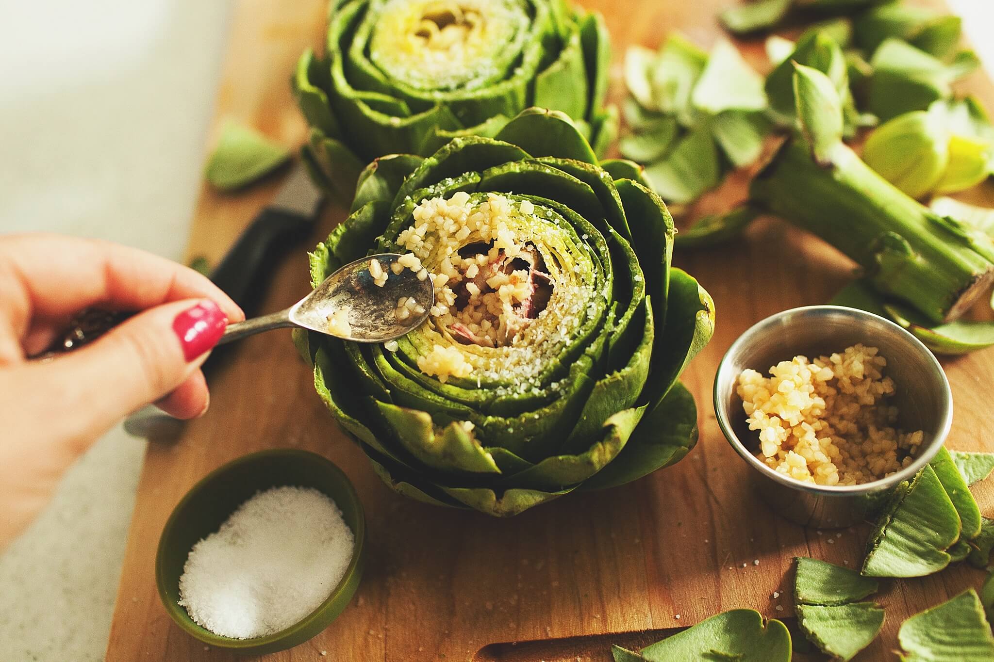 How to Cook Crockpot Artichokes: Top with salt and garlic