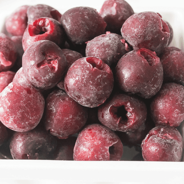 frozen cherries in white bowl