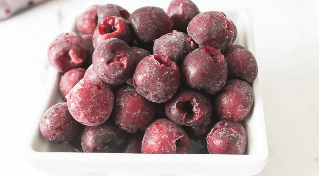 frozen cherries in white bowl