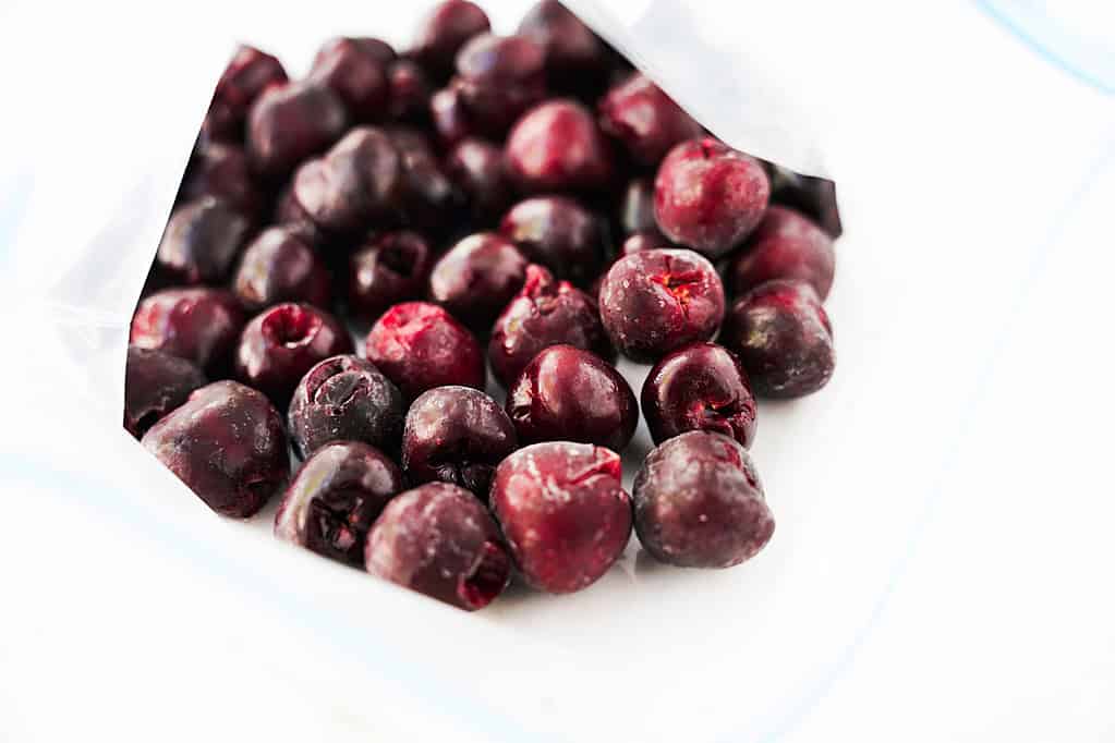 placing flash-frozen cherries in bag for freezing