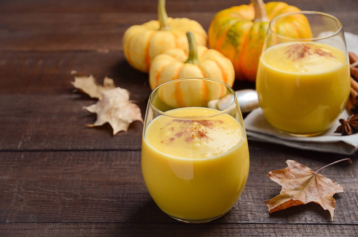Two glasses of Pumpkin Spice Smoothie on a wooden surface