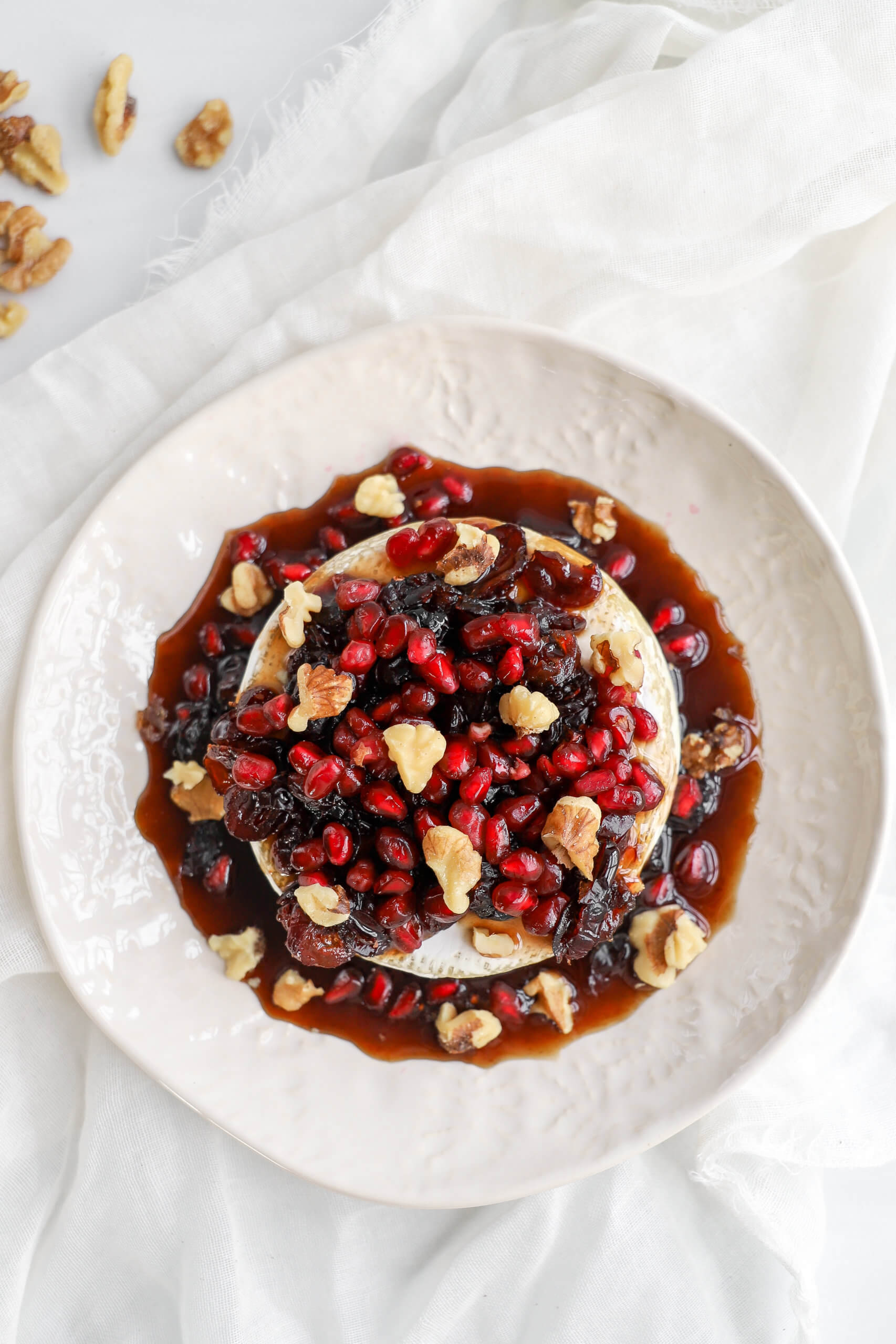 Sweet Baked Brie with Pomegranates, Cranberries, and Walnuts