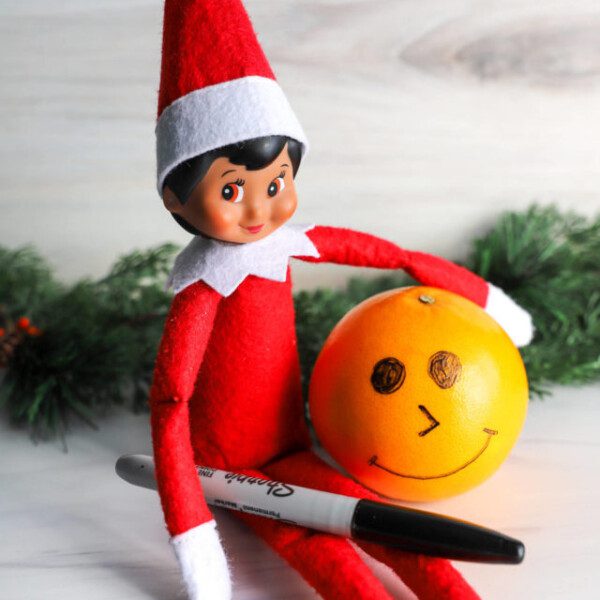 elf on shelf drawing on fruit