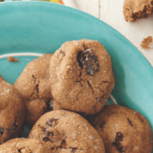 Flat lay photo of a teal plate with Cranberry Cookies, on a white surface