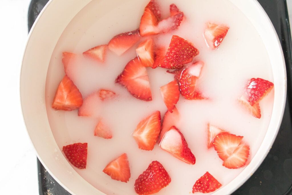 strawberries ina pan with sugar and water
