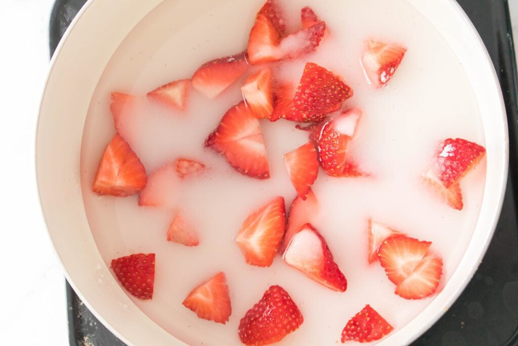 strawberries ina pan with sugar and water