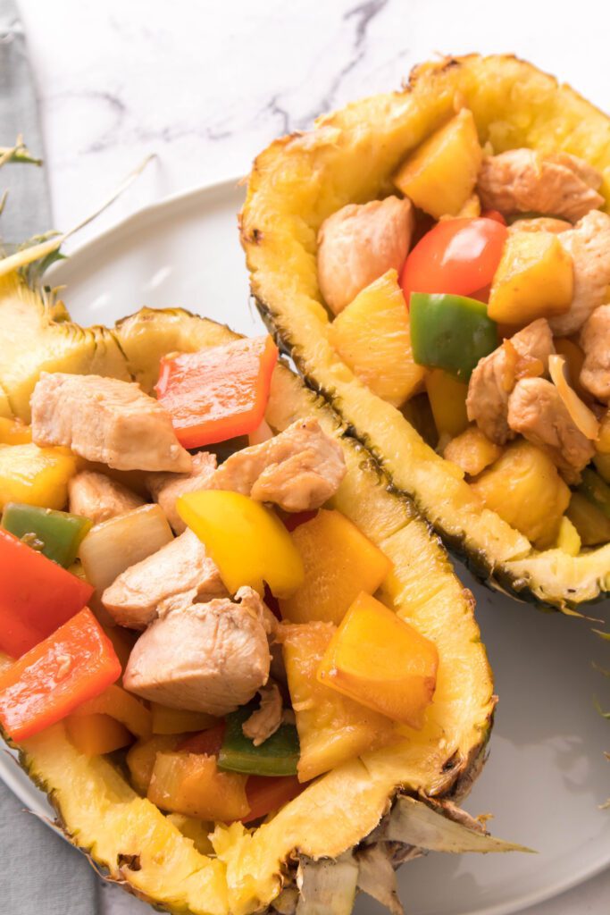 Teriyaki Chicken Pineapple Bowls: Showcasing the fruits and veggies (pineapple, bell peppers, onions) and chicken