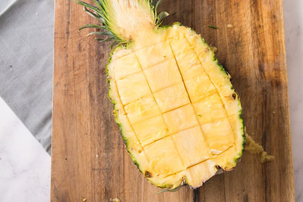 Pineapple with knife marks showing how to cut pineapple chunks