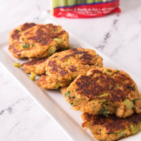 vertical shot of crab cakes on a white serving platter