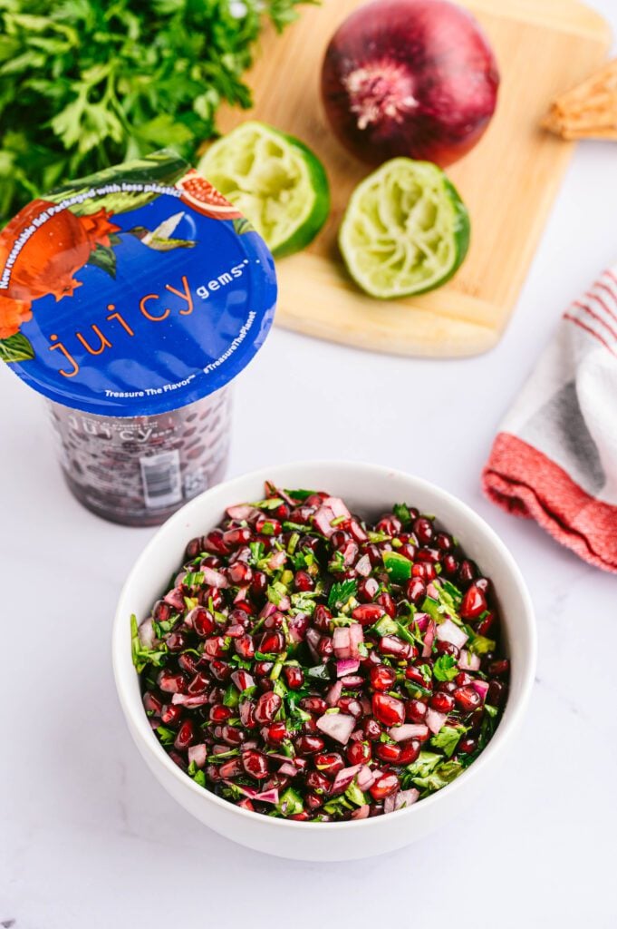 Pomegranate Salsa with ingredients in the background