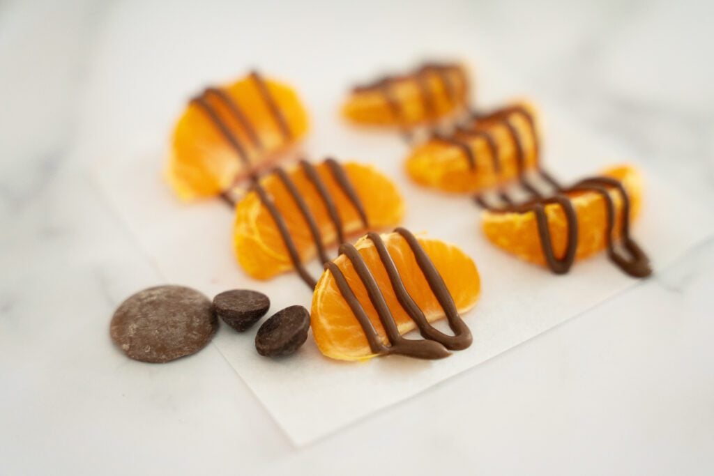 Orange segments covered with drizzled chocolate melt