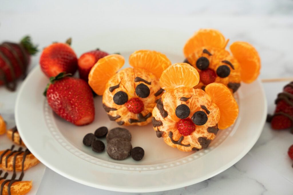 Orange tigers ona plate with strawberries and chocolate chips