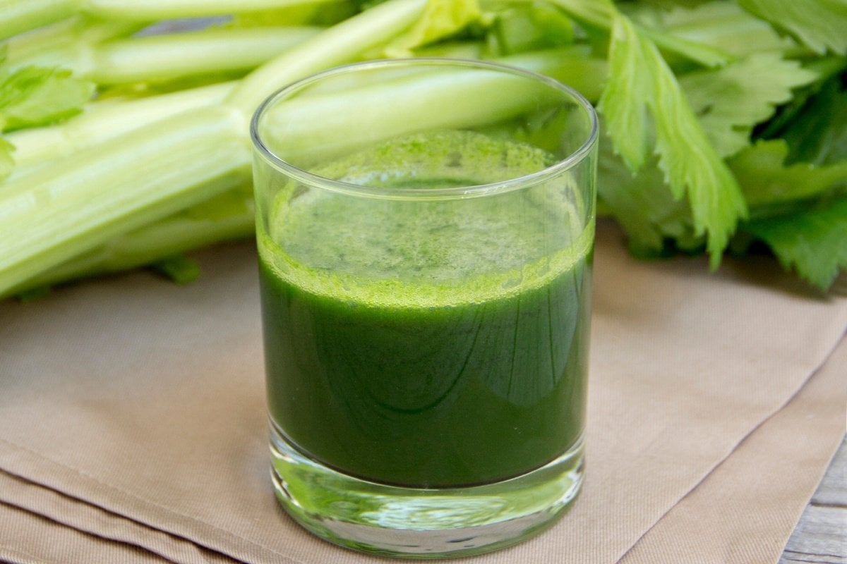 Celery Juice surrounded by celery stalks