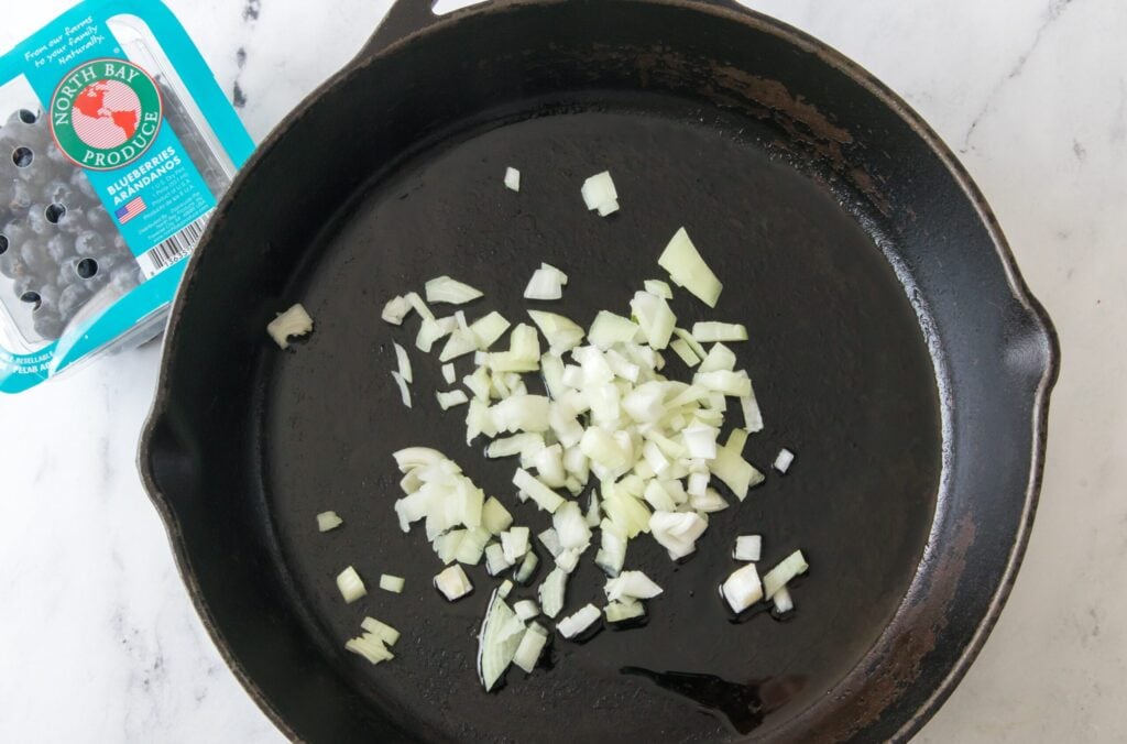 Overhead view of onions in skillet