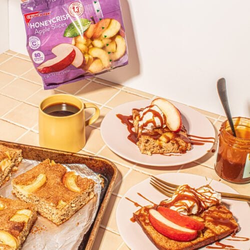 Sheet pan apple pancakes with a bag of Crunch Pak apples and a cup of coffee
