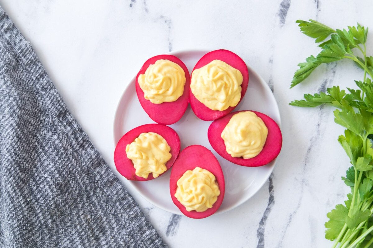 Overhead view of dyed boiled eggs using beet juice