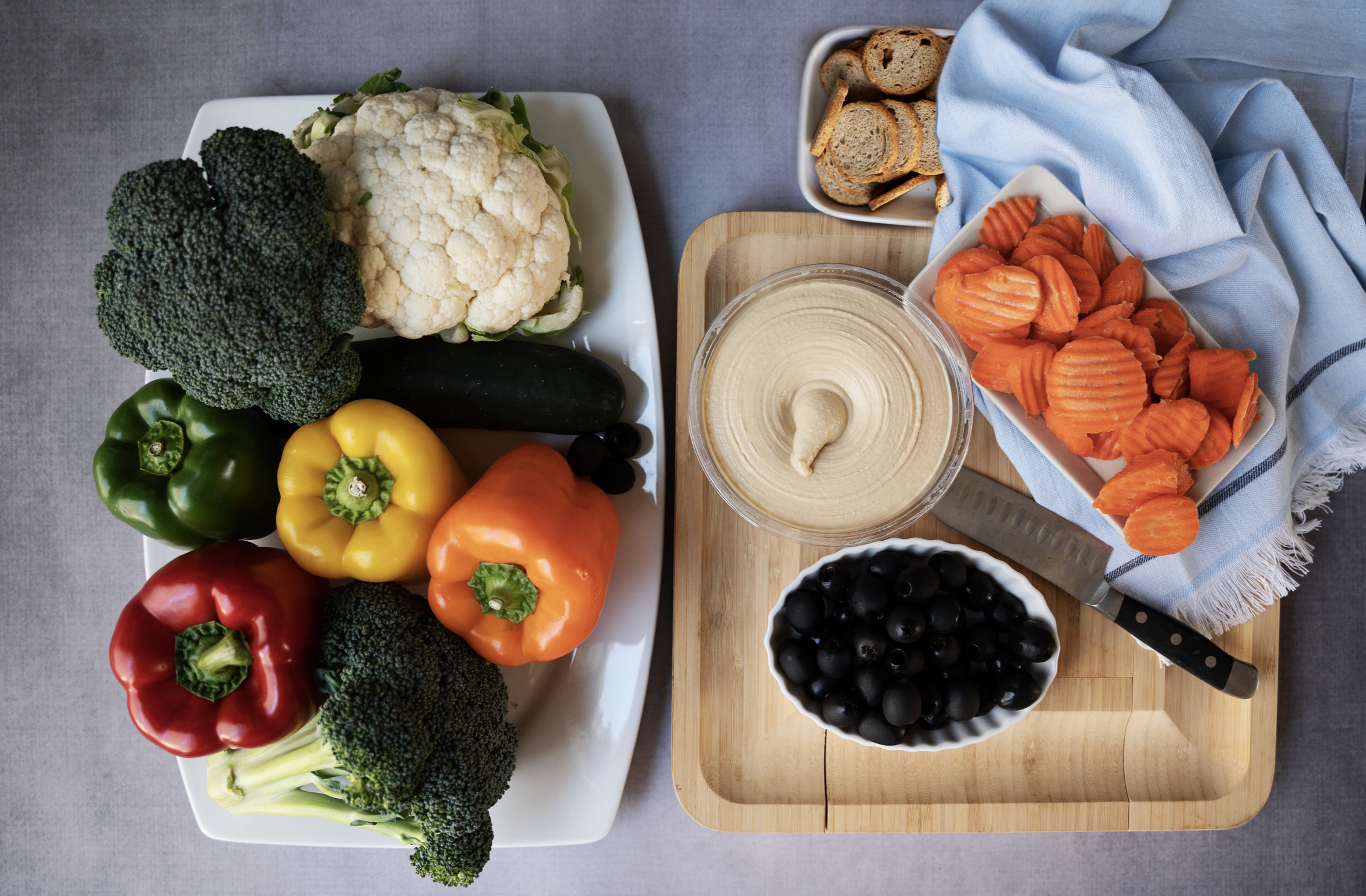 Overview of veggies for Leprechaun tray (bell peppers, broccoli, cauliflower, carrots, black olives) + hummus