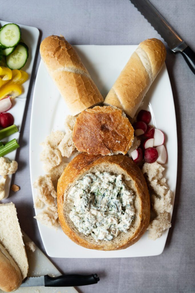 spinach artichoke bread bowl on cutting board in the shape of a bunny