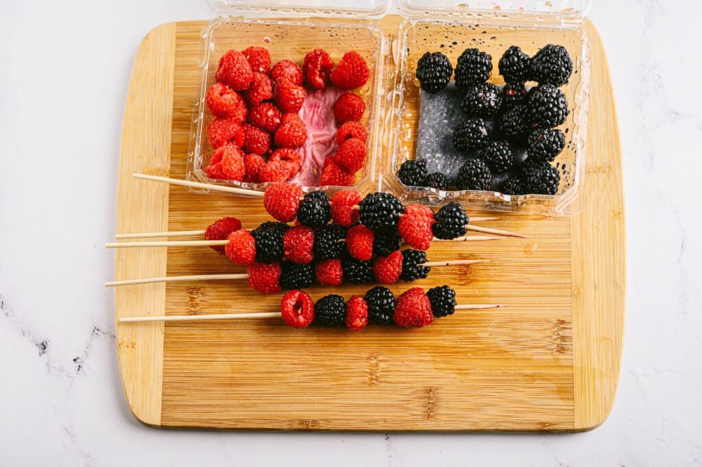 berries in containers and on skewers