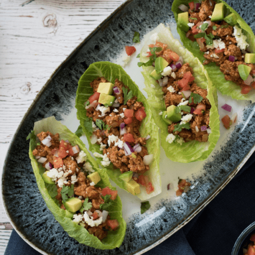 Plate of lettuce wraps with taco fillings