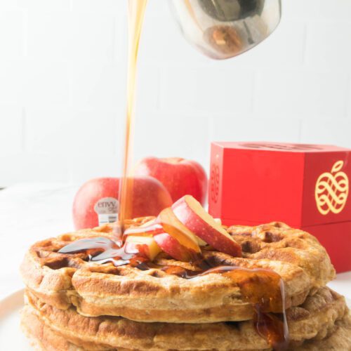 apple cinnamon waffles on a white place with apples in the background