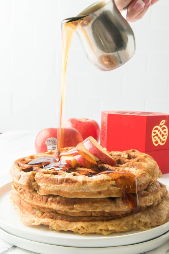 apple cinnamon waffles on a white place with apples in the background