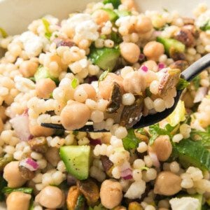 fork holding jennifer aniston salad recipe over bowl