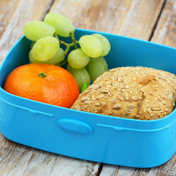 Mandarin in lunch box with grapes and sandwich