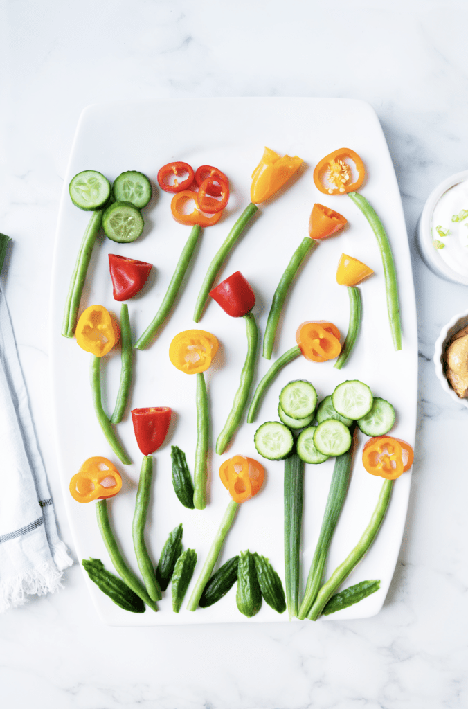 white plate with various veggies styled as flowers