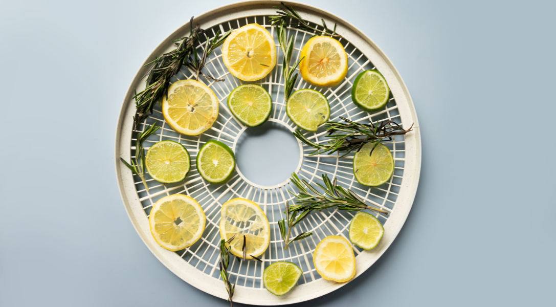 Lemon and lime with herbs on drying pan