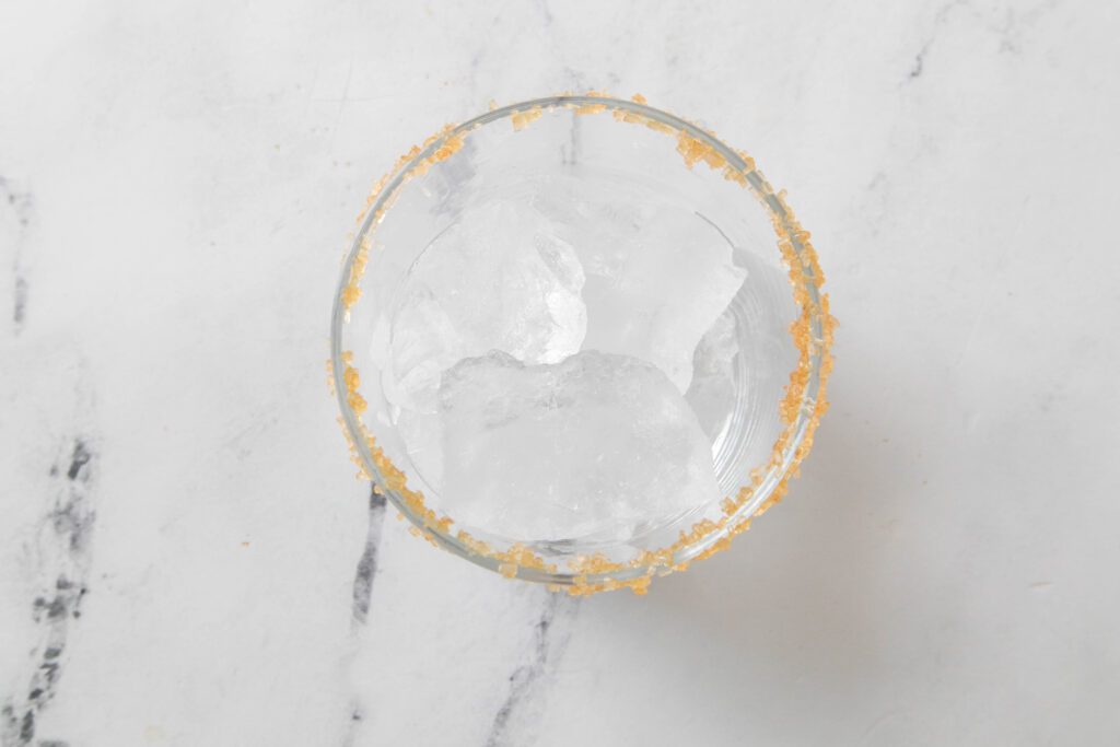 glass with ice and raw sugar rim