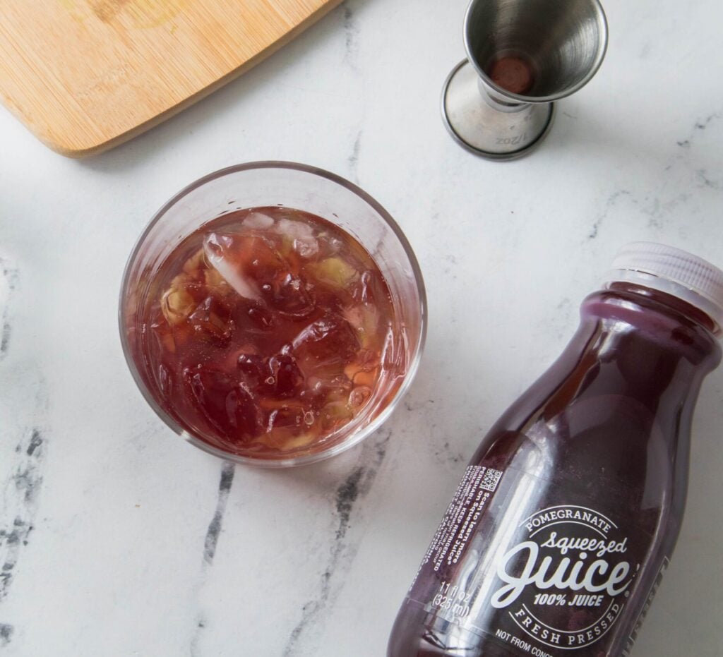 Cup with adding honey water to muddled cucumbers + Pomegranate Squeezed Juice