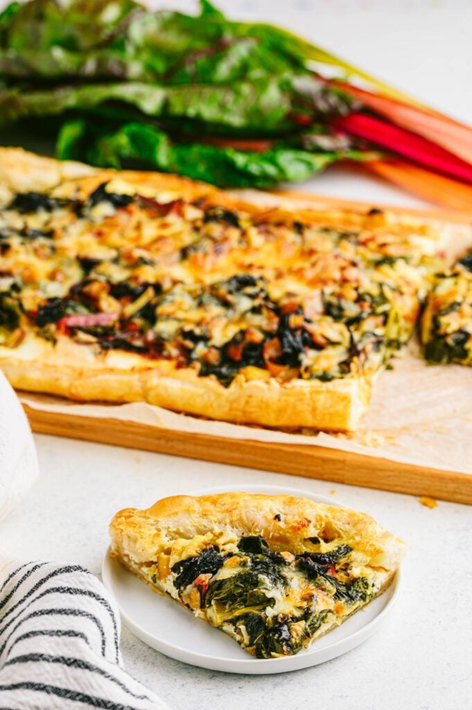 swiss chard tart slice on a white plate