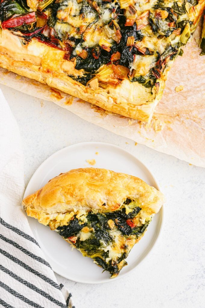 swiss chard tart slice on a white plate