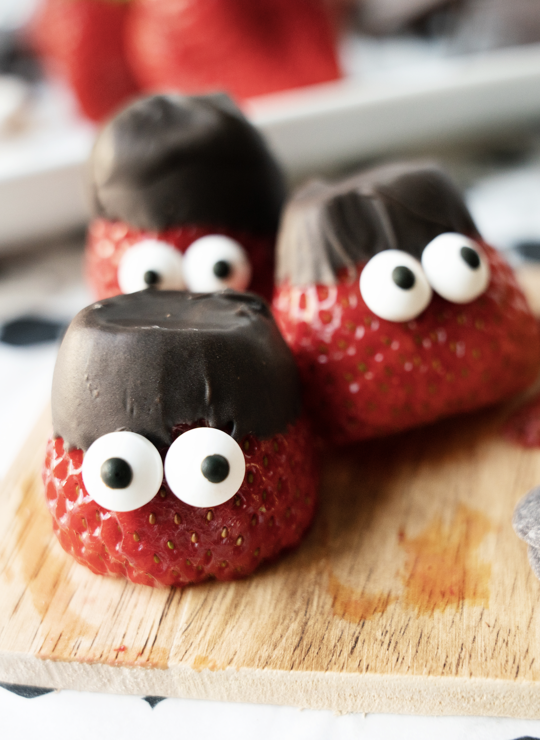 Chocolate covered strawberries at the top with candy eyes