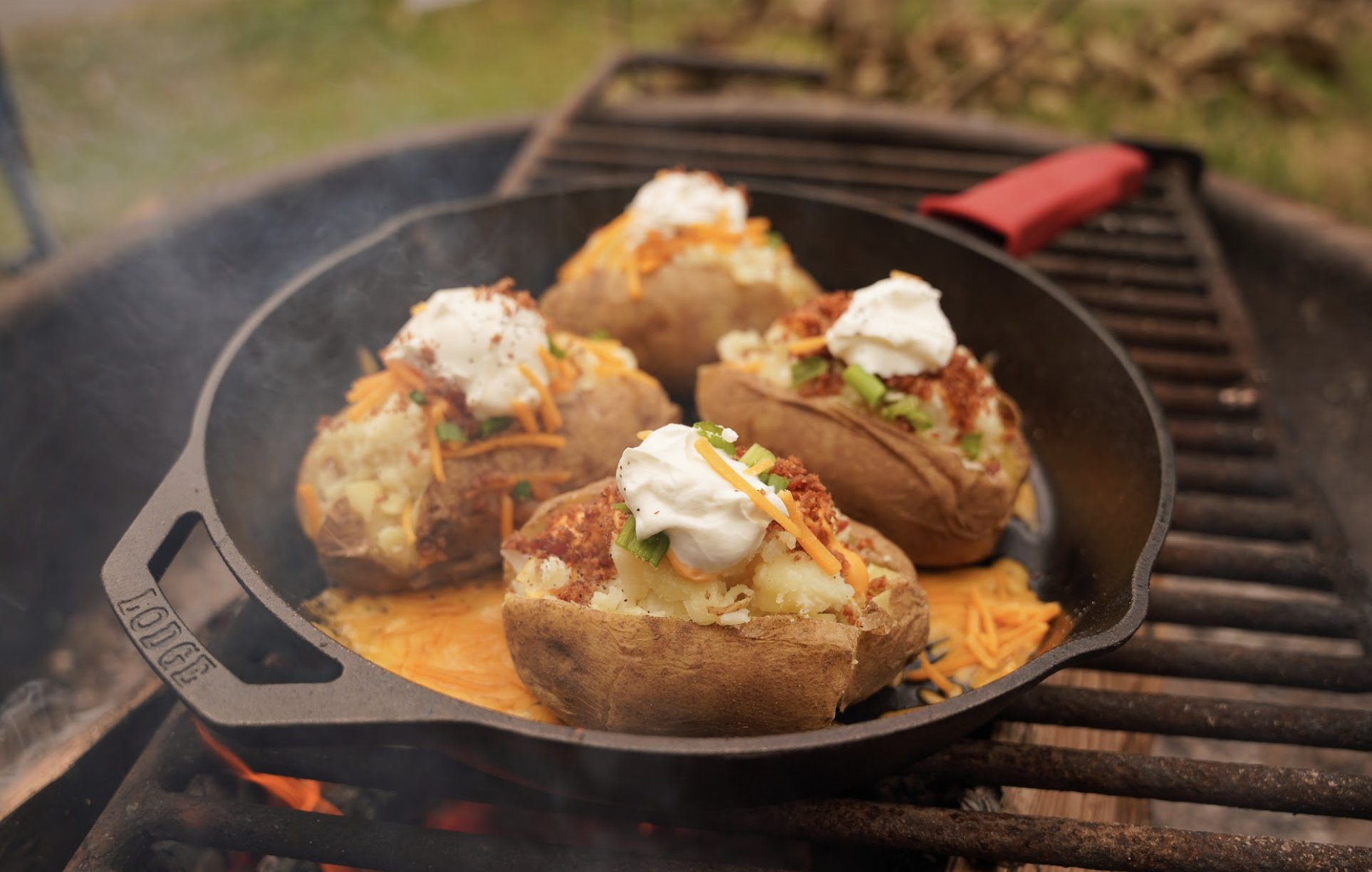 Potatoes in a cast iron skillet over a grill