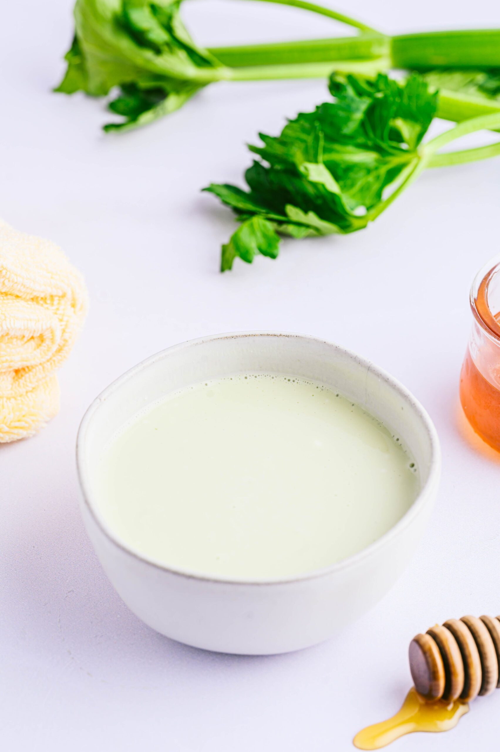 Celery Hair Mask in bowl surrounded by towel and ingredients