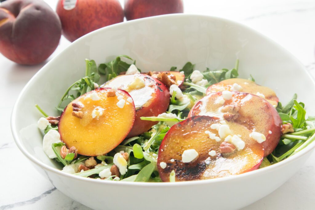 Grilled Peach salad in white bowl