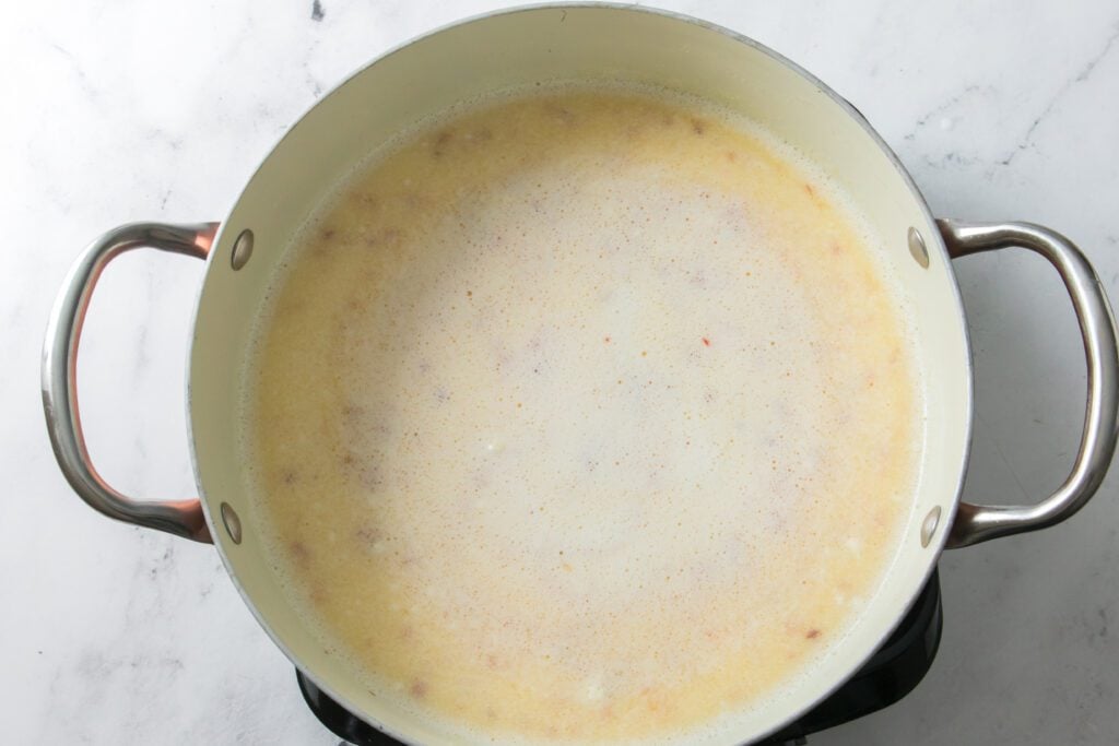 milk, butter and hot honey added to water in pot