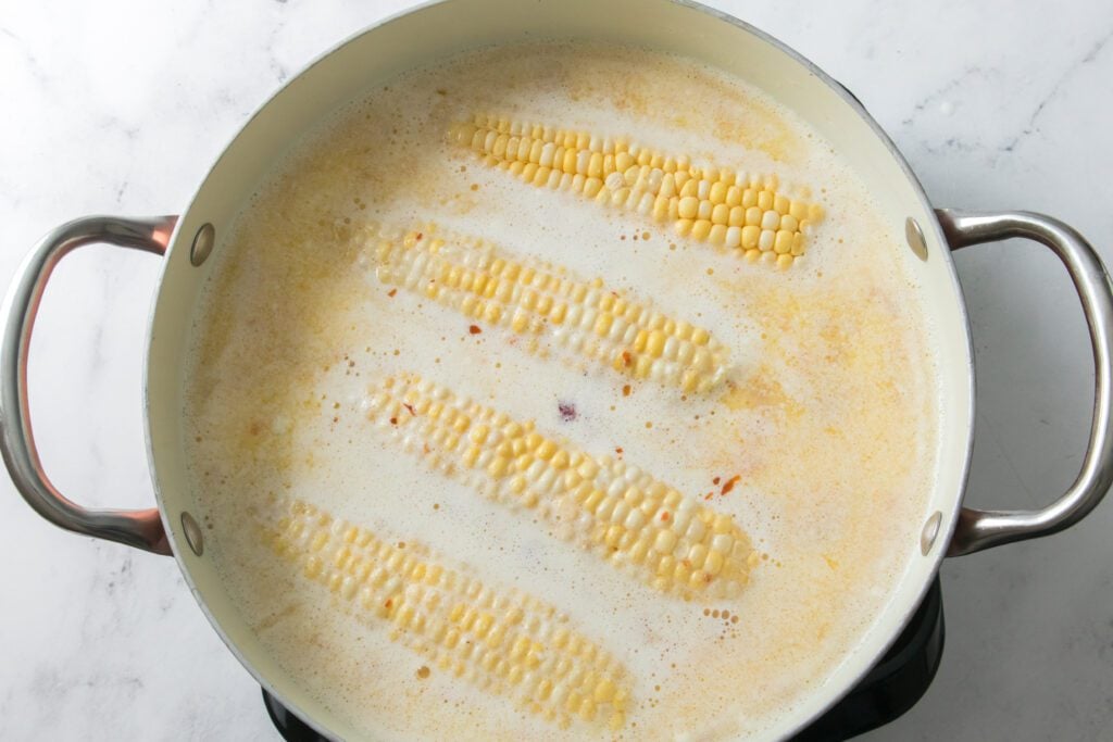 cobs of corn in a hot honey bath