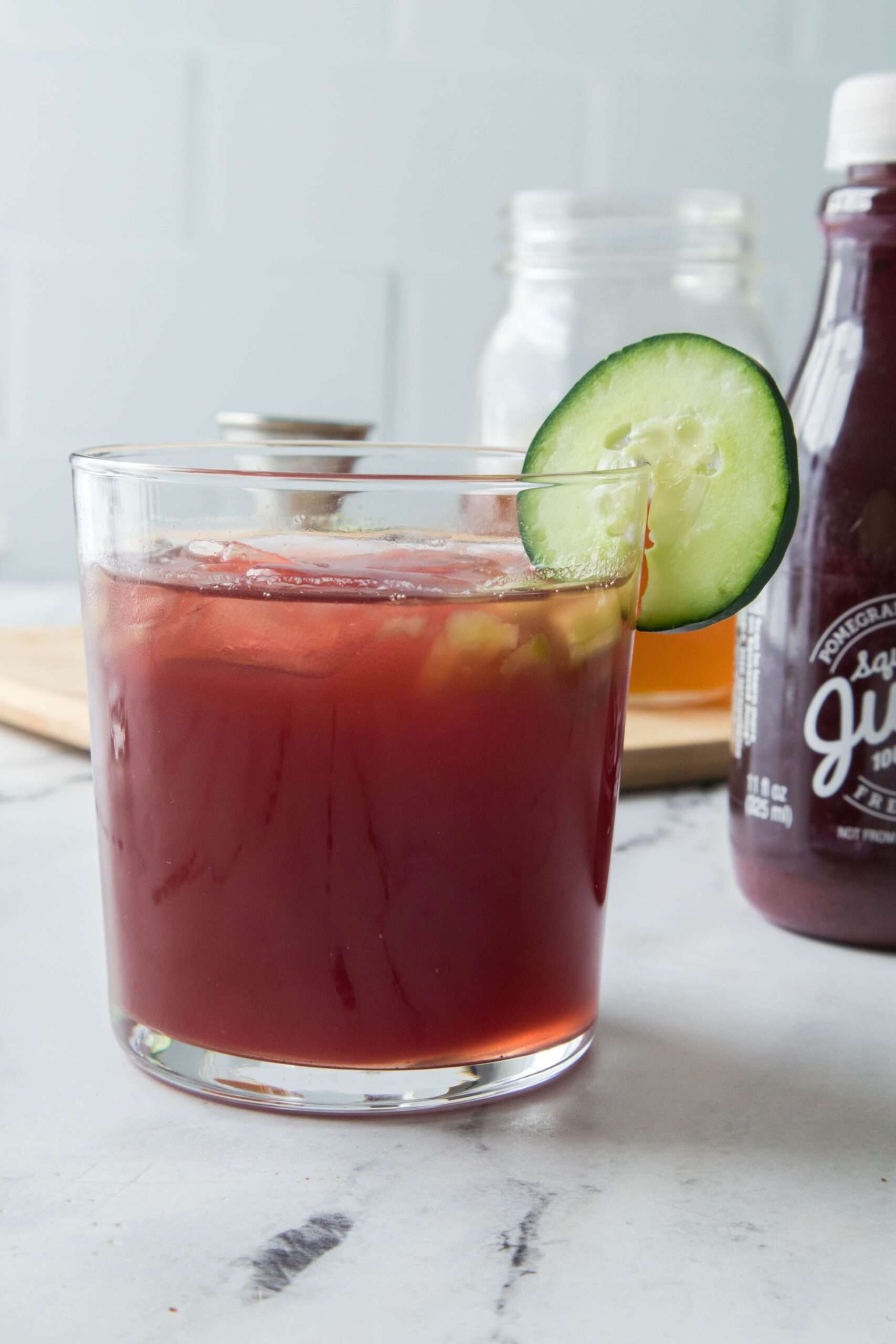 Pomegranate Cocktail with ingredients in background