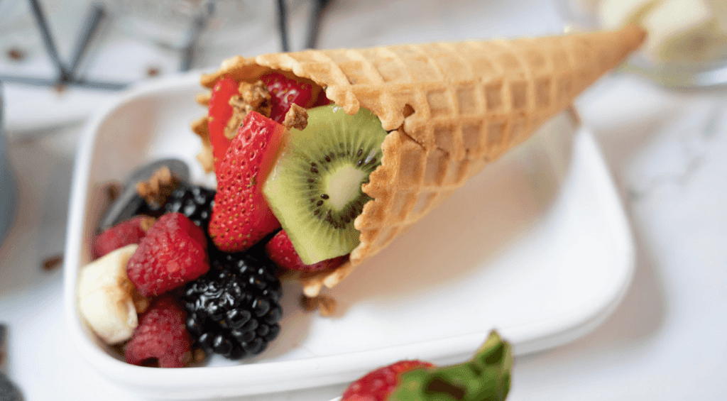 Fruit Salad in a Waffle Cone laying on a plate