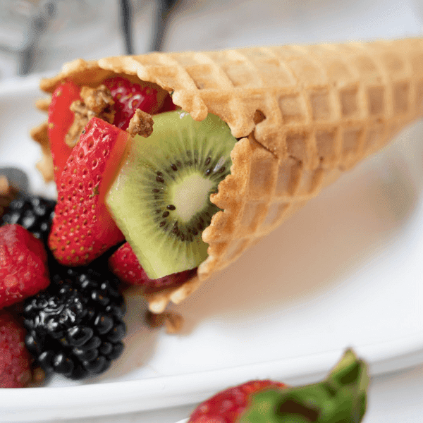 Fruit Salad in a Waffle Cone laying on a plate