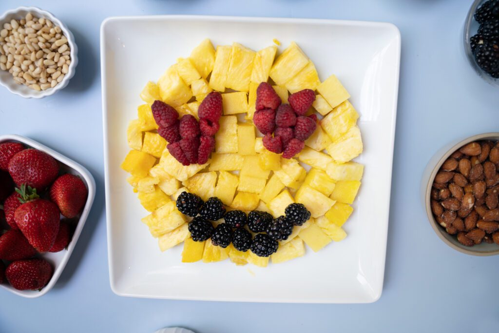 seeing love emoji made from pineapple, raspberries and blackberries