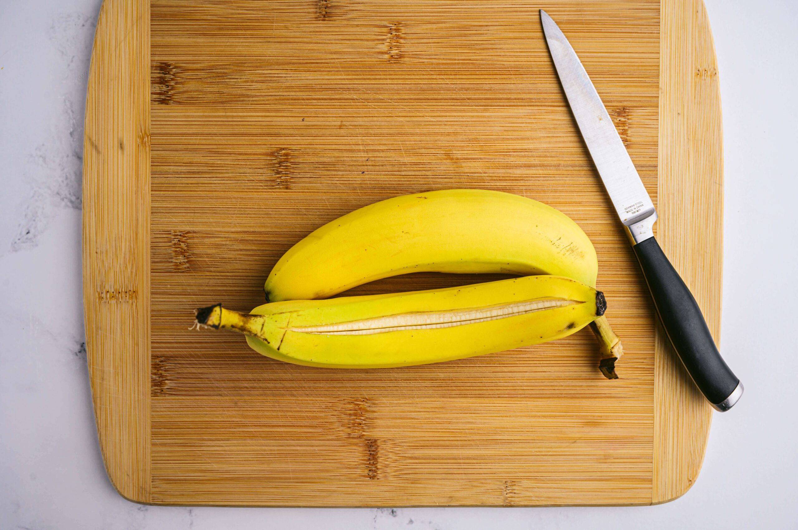 knife cutting through skin of a banana
