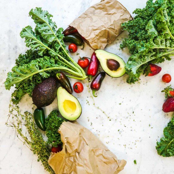 brown paper bags laid out with fruits and veggies