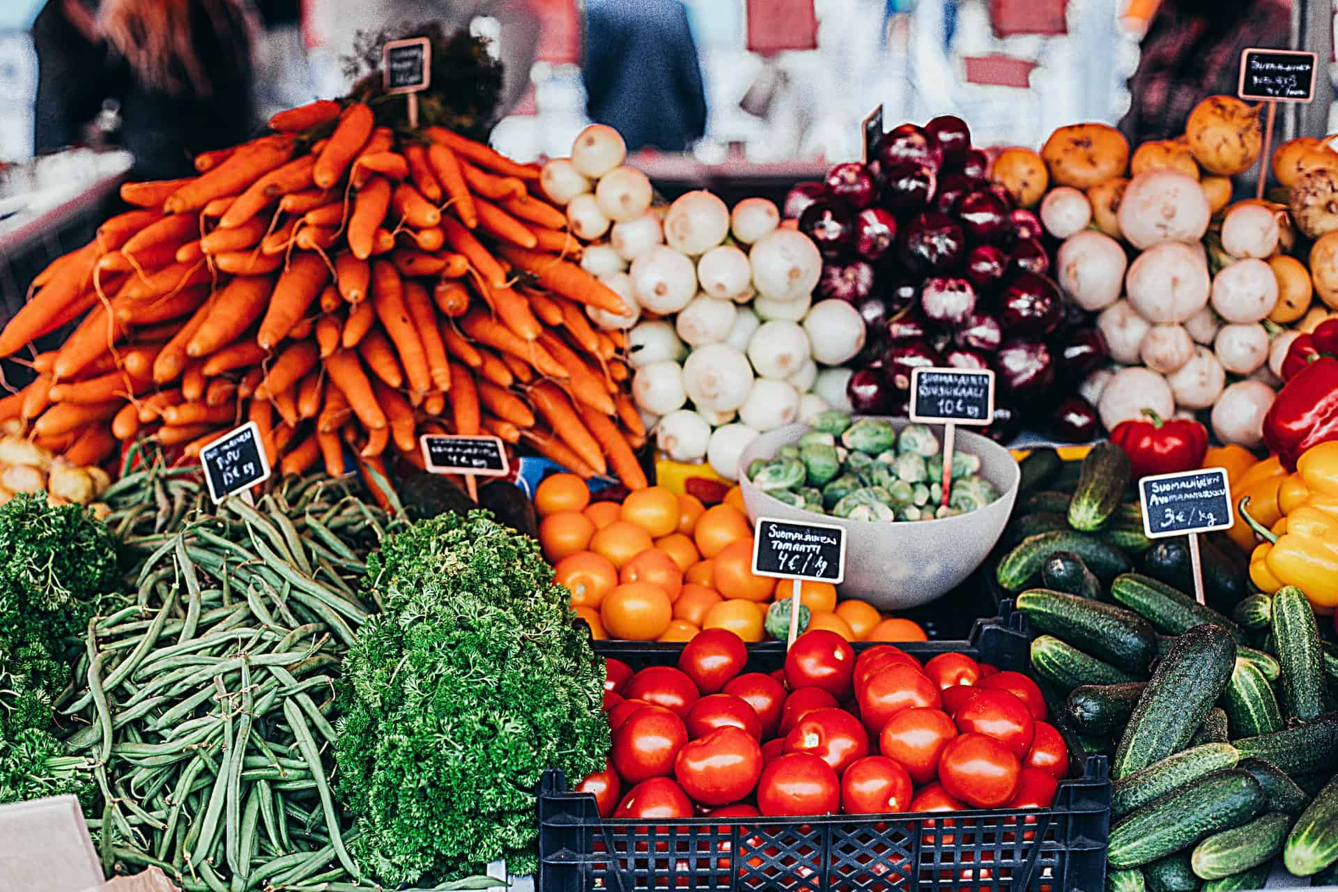 a stack of vegetables with price tags