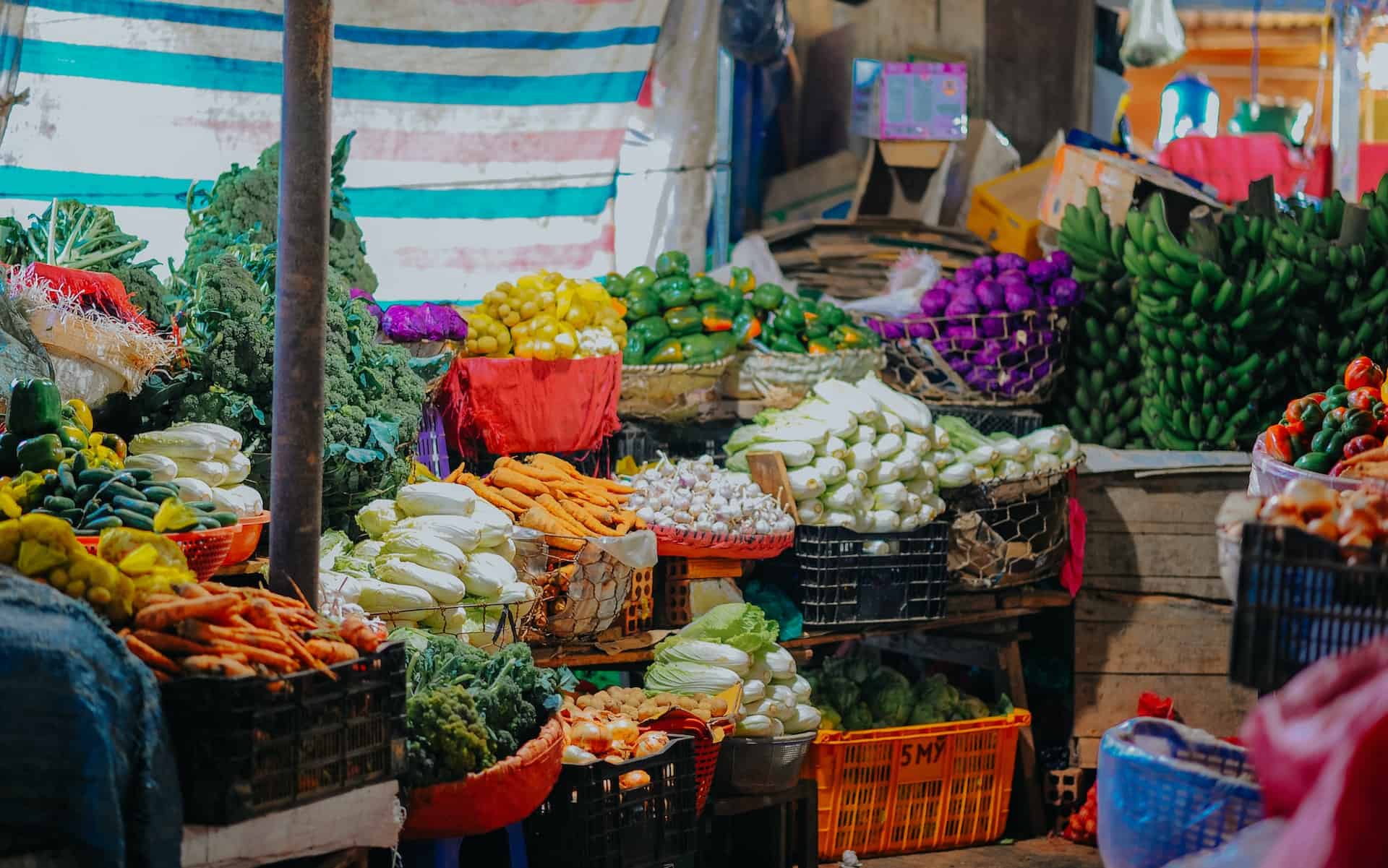 a stall of vegetables in baskets for sale