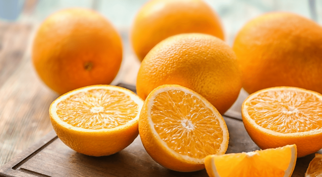 Orange halved on wood counter
