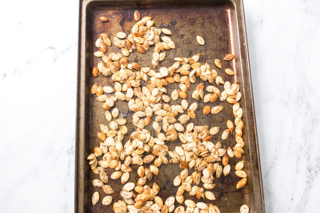 roasted seeds on a baking sheet